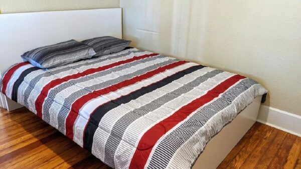 a bed covered with striped sheets
